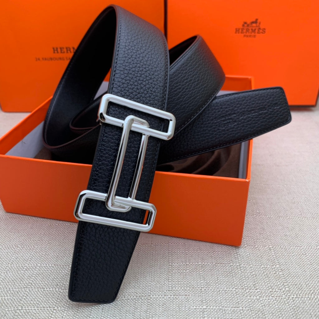 Leather belt with dark navy grain texture and silver-tone double H buckle, looped.