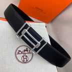 Leather belt with dark navy grain texture and silver-tone double H buckle.
