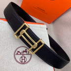 Leather belt with dark navy grain texture and gold-tone double H buckle.