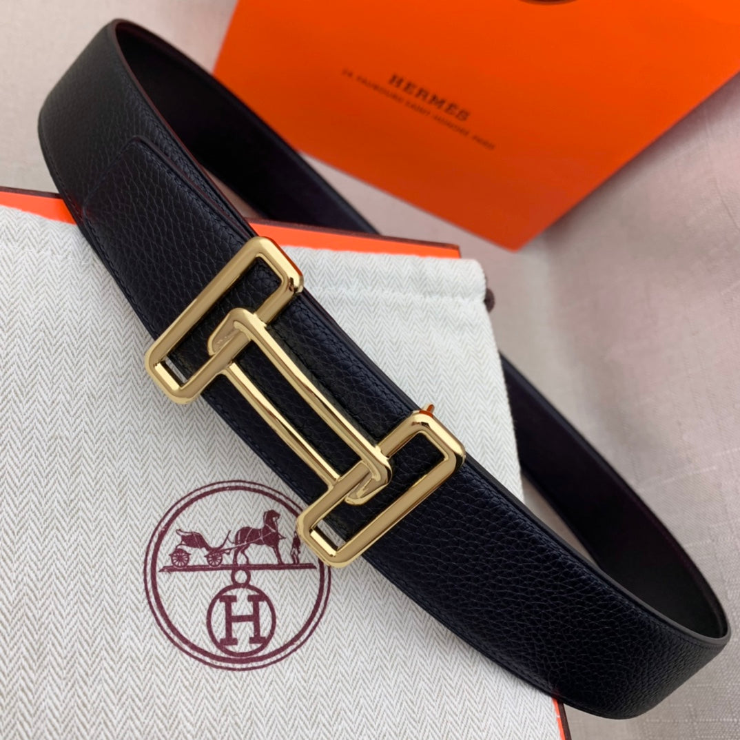 Leather belt with dark navy grain texture and gold-tone double H buckle.