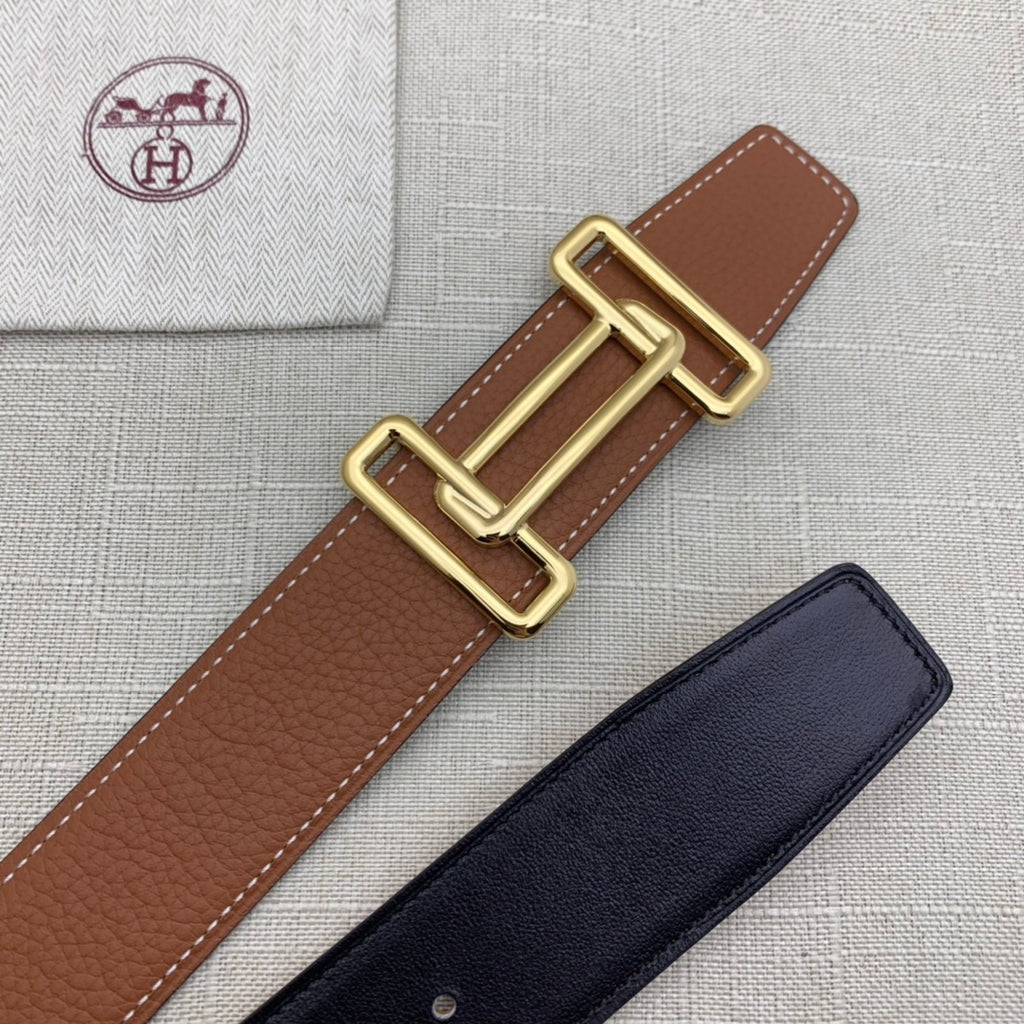 Brown leather belt with gold-tone double H buckle on textured leather strap.