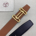 Brown leather belt with gold-tone double H buckle on textured leather strap.