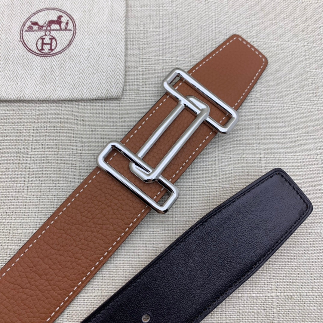 Brown leather belt with silver-tone double H buckle and dark blue belt underside.