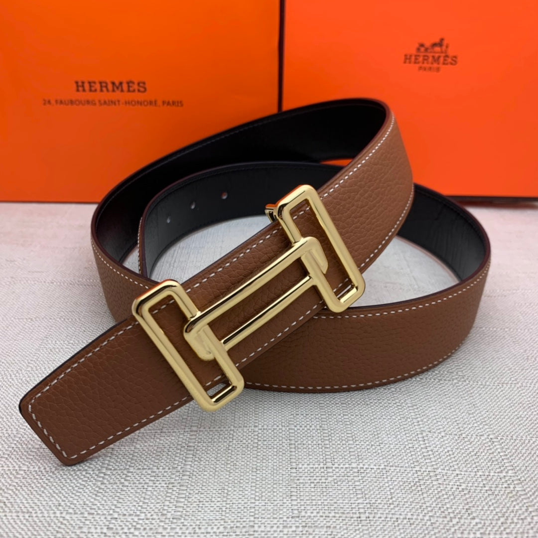 Brown leather belt with gold-tone double H buckle and dark inner lining.