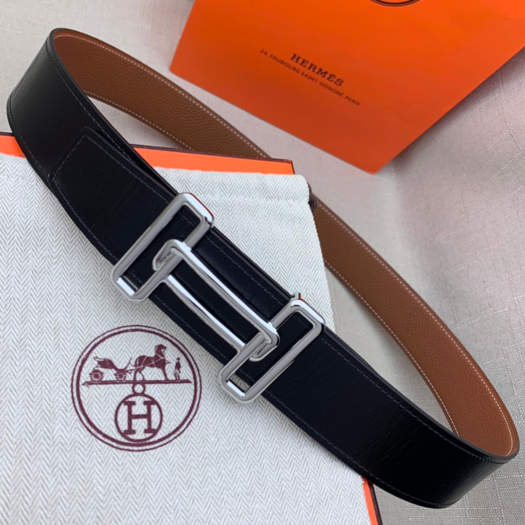 Black leather belt with silver-tone double H buckle and contrast stitched edge.