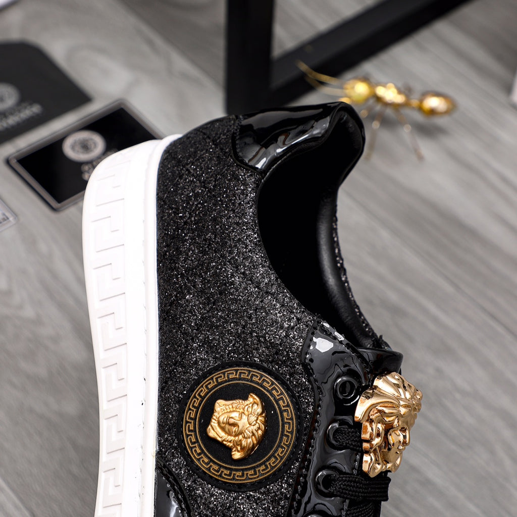 Versace black sneakers side view with gold lion emblem and ornate lace hardware