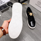 Versace black sneakers with textured white outsole and patent black upper