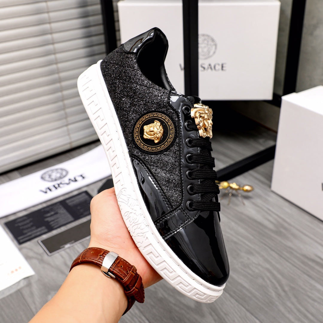 Versace black sneakers with side gold lion emblem, black laces, and white platform sole
