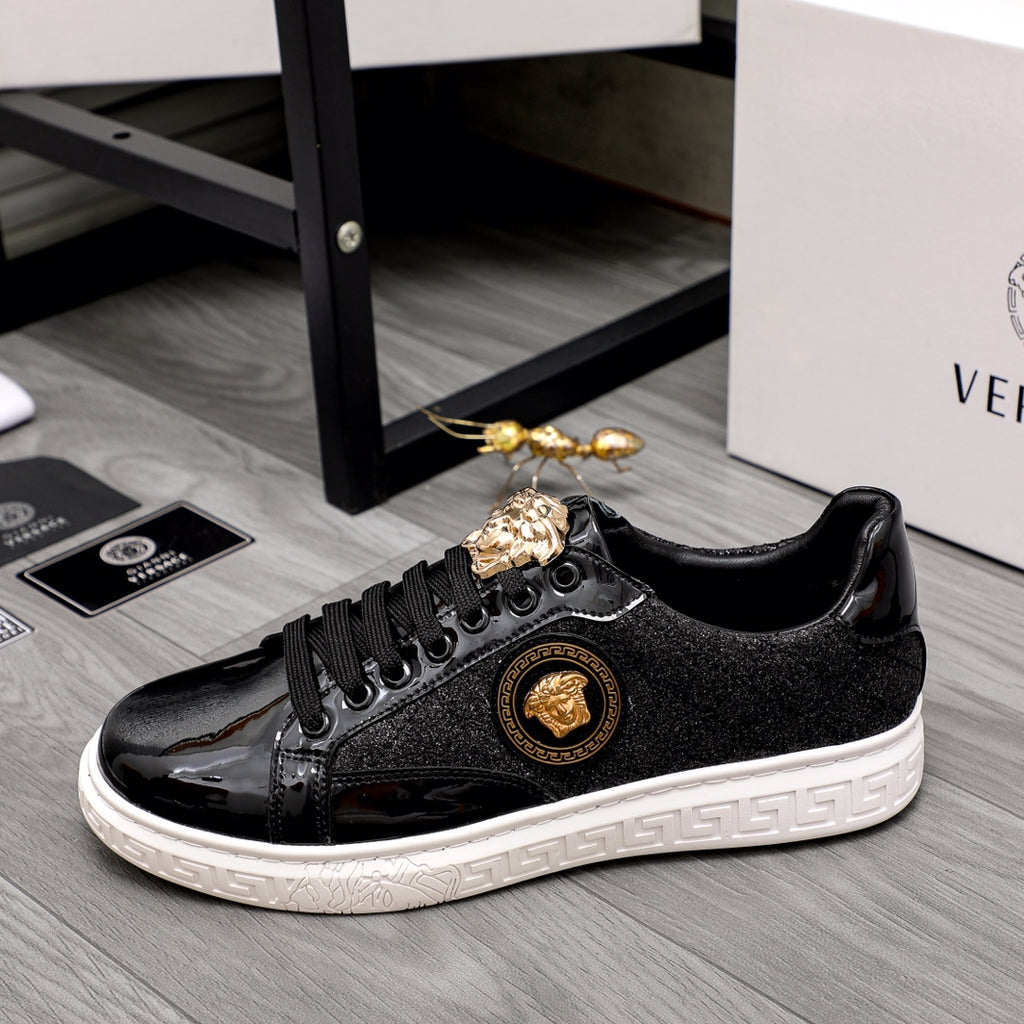 Versace black sneakers with gold crest medallion, glossy toe, and white sole