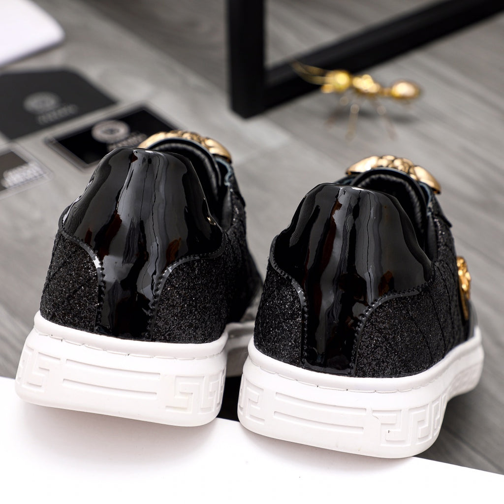 Versace black sneakers with gold accents, back view, and white outsole