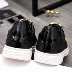 Versace black sneakers with gold accents, back view, and white outsole