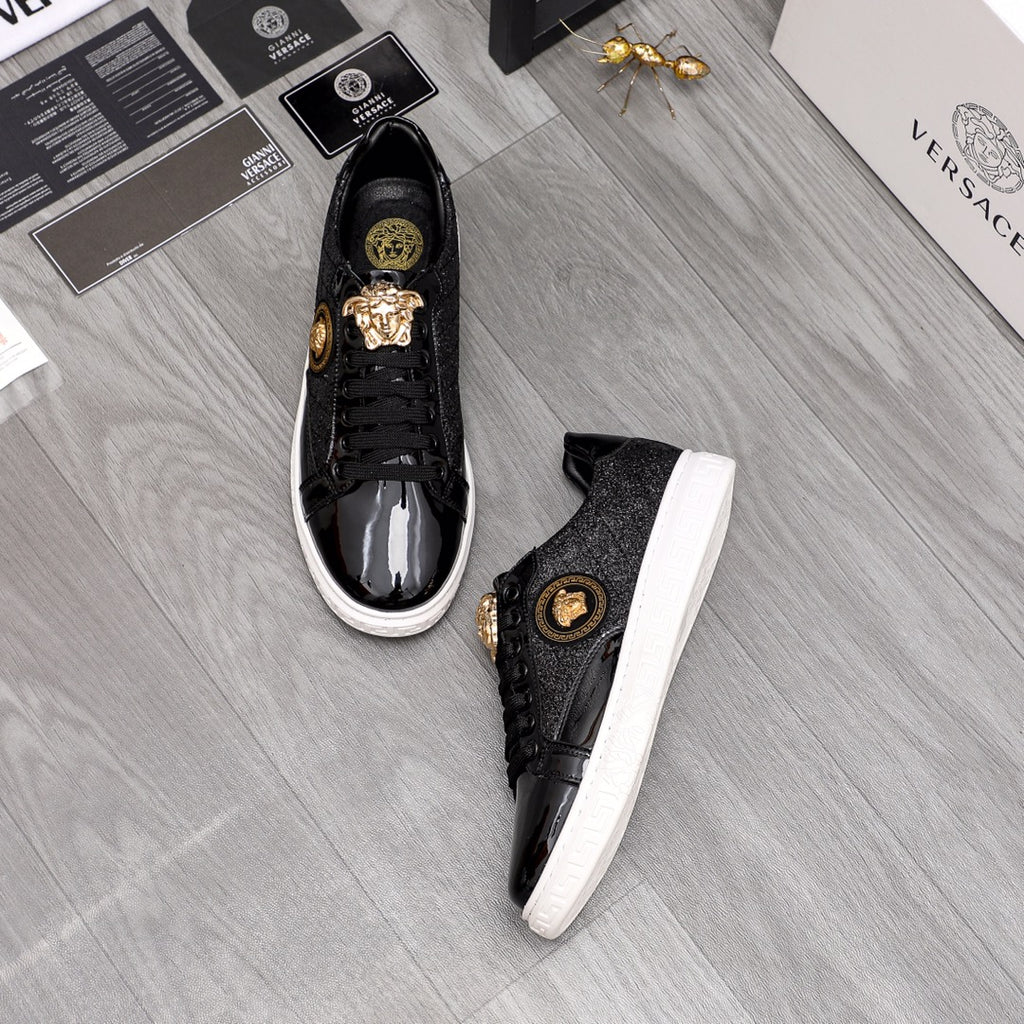 Versace black sneakers pair with gold lion crest and white rubber sole