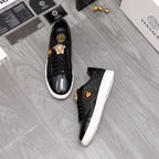 Versace black sneakers pair with gold lion crest and white rubber sole