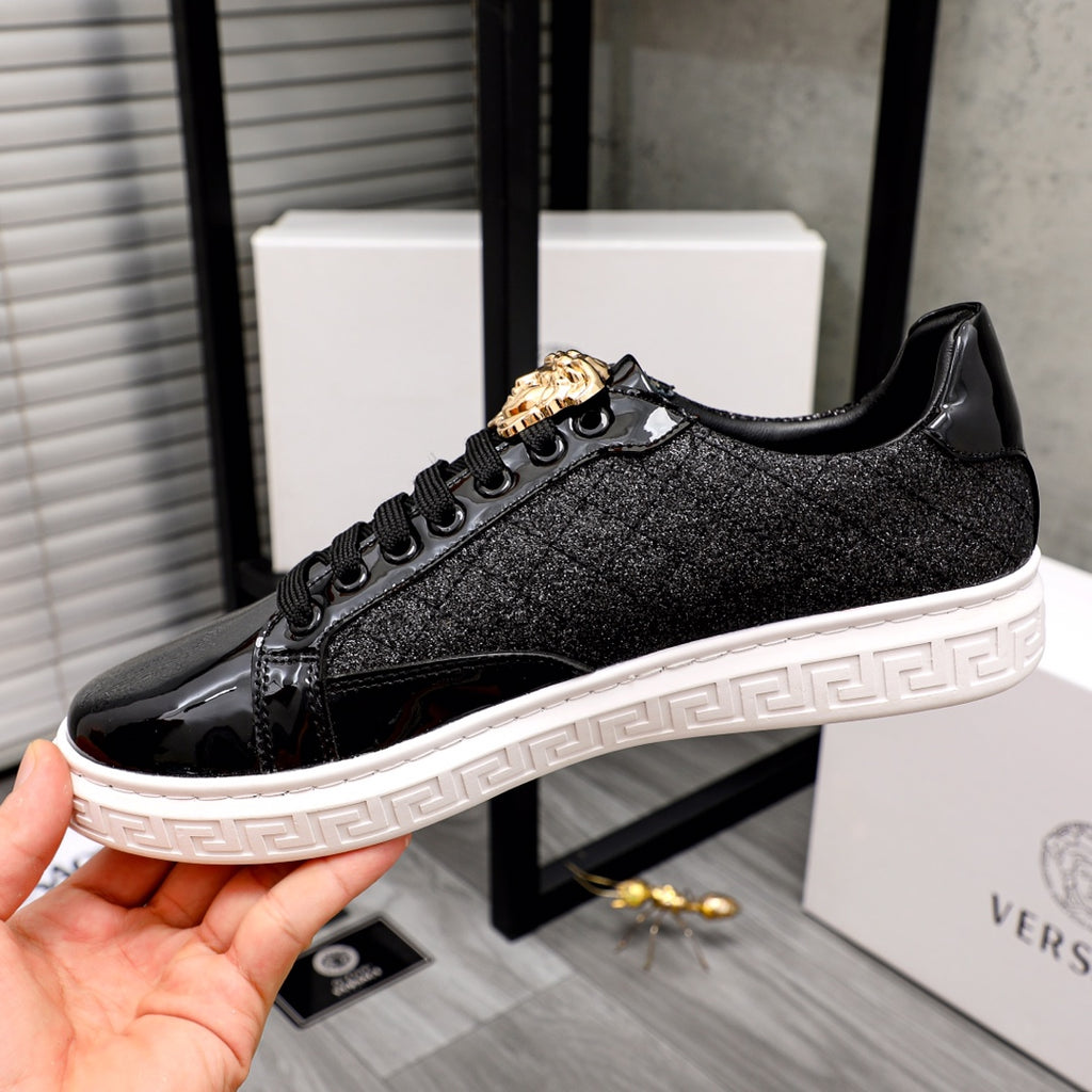Versace black low-top sneakers with gold lion detail and embossed white sole