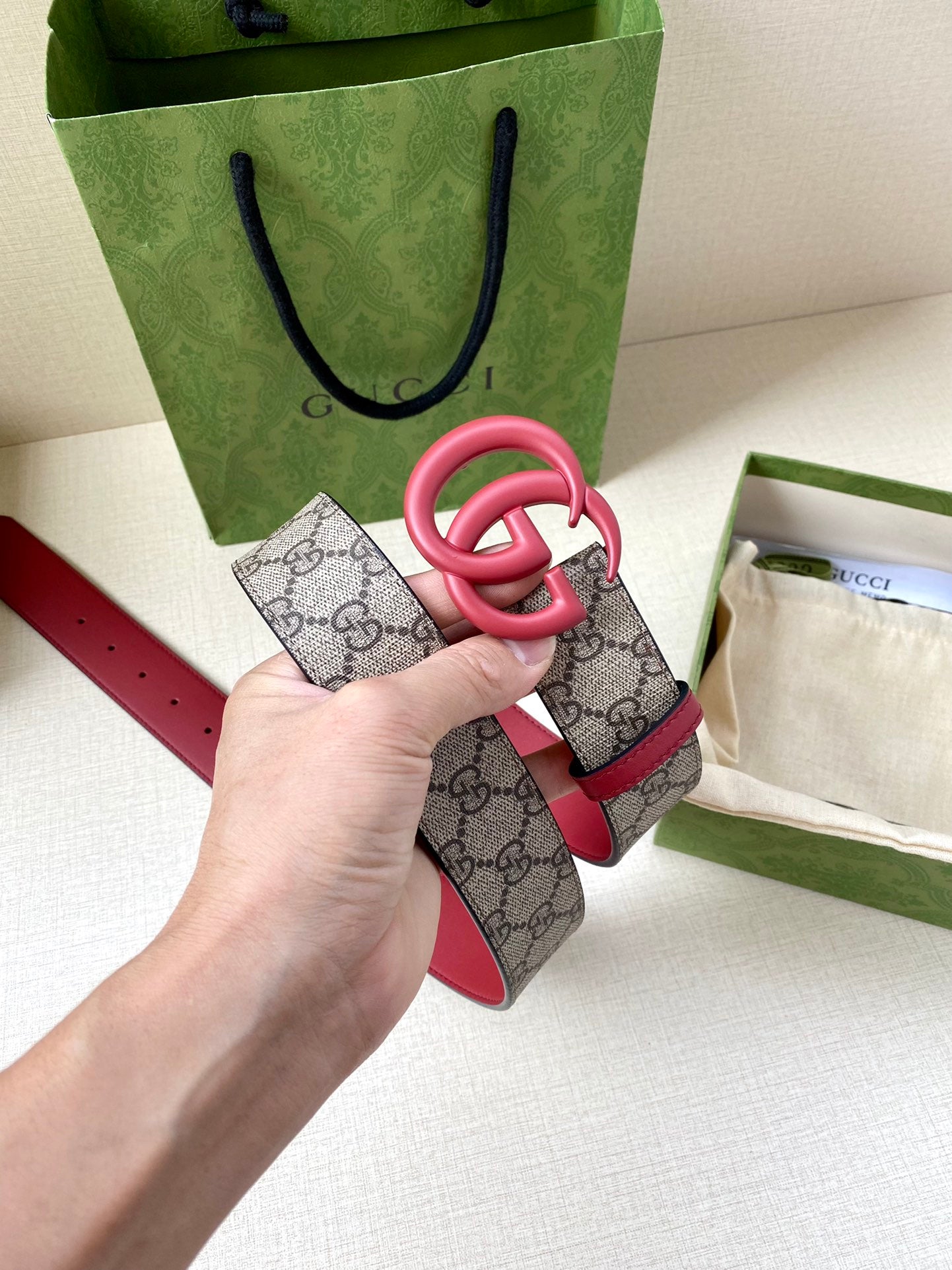 GG monogram belt strap with red leather lining and pink double-G buckle
