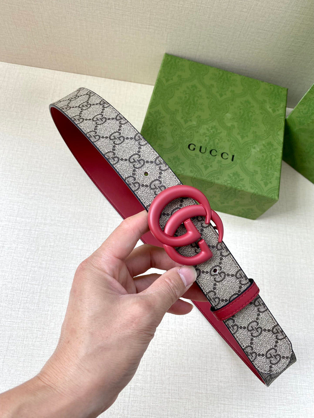 GG monogram canvas belt with red strap and pink double-G buckle