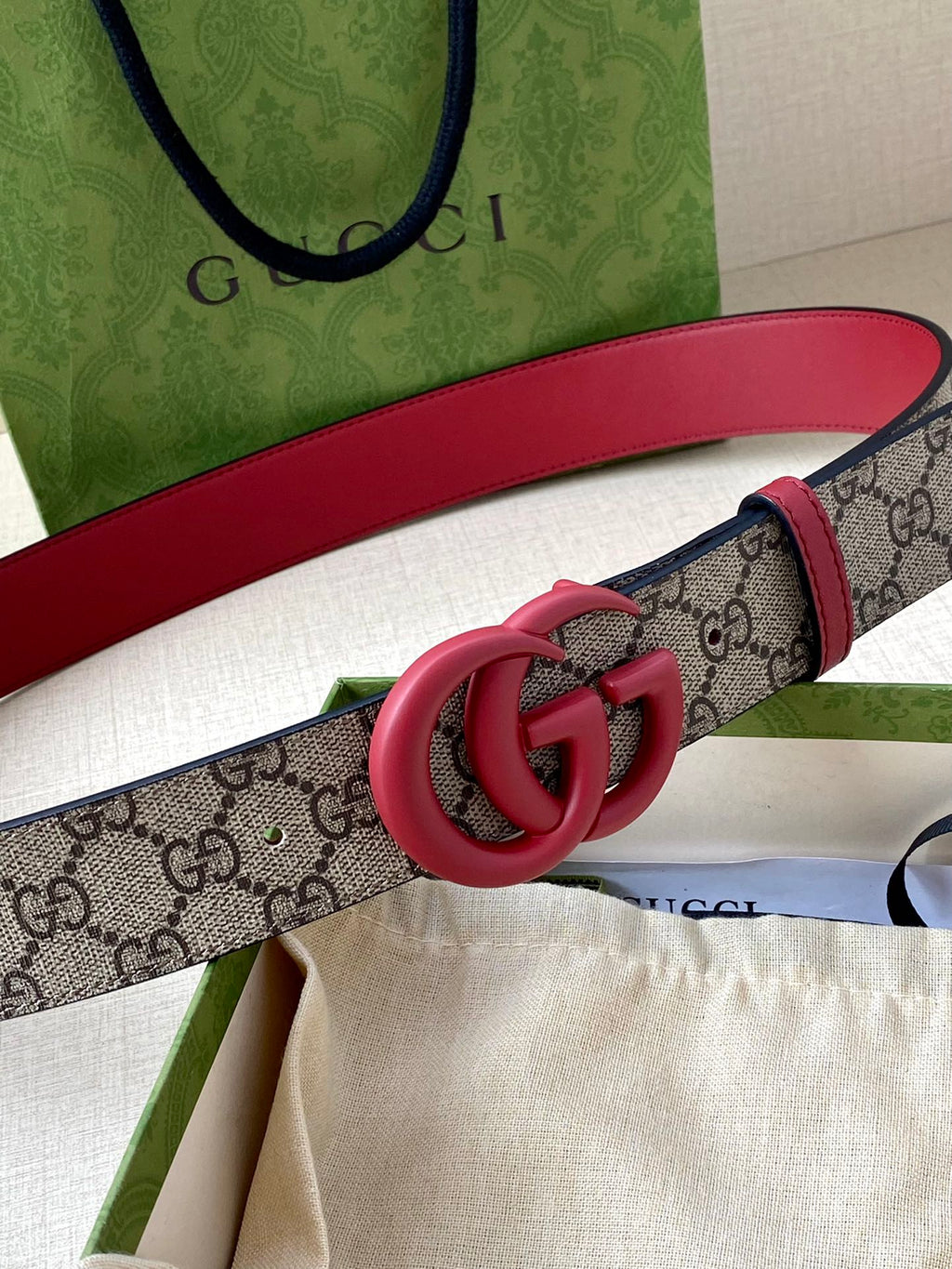 GG monogram belt with red leather and pink double-G buckle close-up