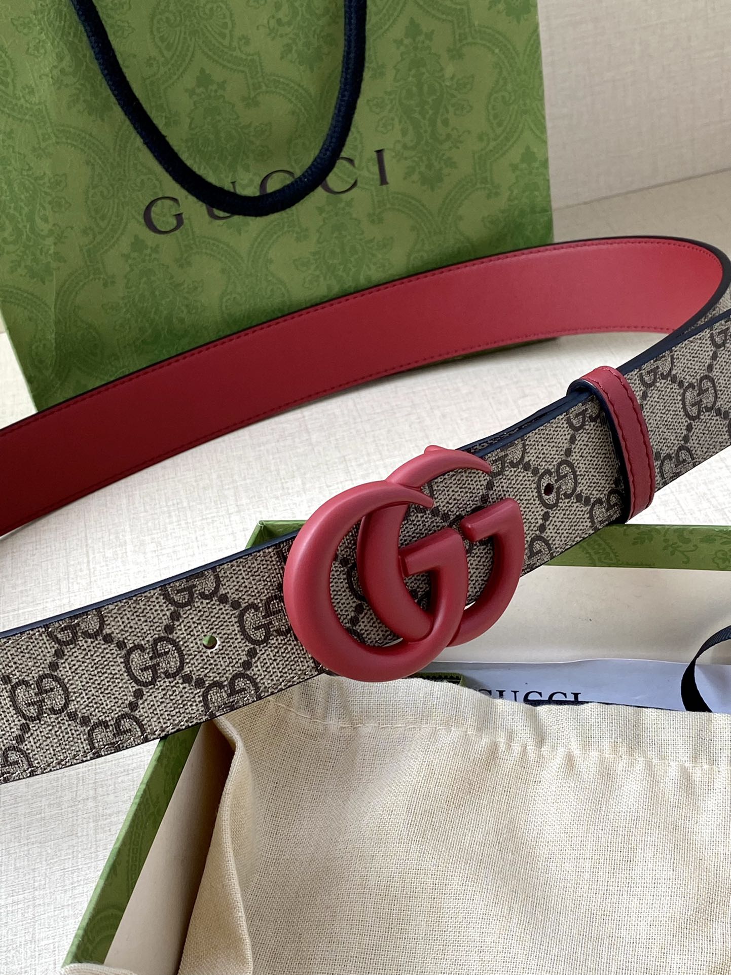 GG monogram belt with red leather and pink double-G buckle close-up
