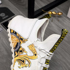 Versace sneakers with white upper, gold baroque side panel, and lace-up with Greek key trim