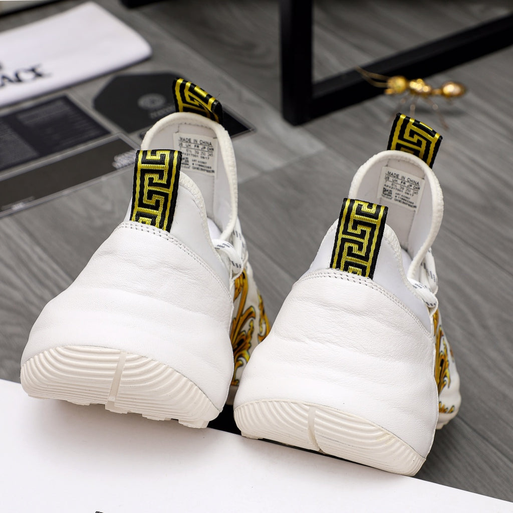 Versace sneakers back view: white cushioned heels with gold baroque accents and thick soles