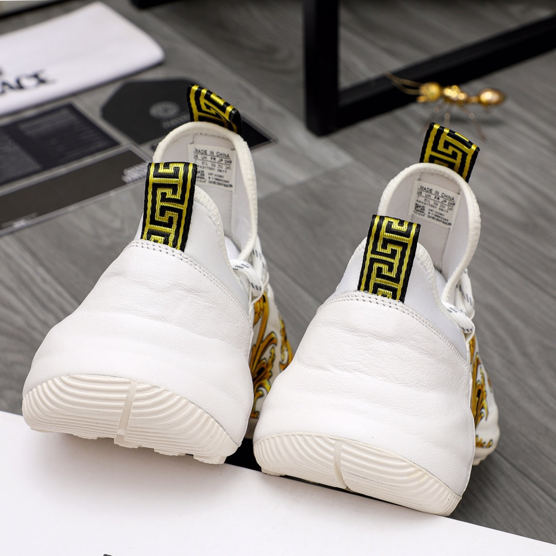 Versace sneakers back view: white cushioned heels with gold baroque accents and thick soles