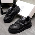 Black lace-up sneakers with chunky sculpted sole and Versace logo tongue label.