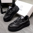Black lace-up sneakers with chunky sculpted sole and Versace logo tongue label.