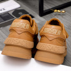 Luxury shoes: tan sneakers from back showing raised logo and cushioned heel collar