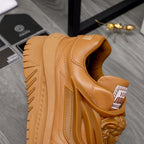 Luxury shoes: tan sneaker side view with cushioned collar and thick tread sole