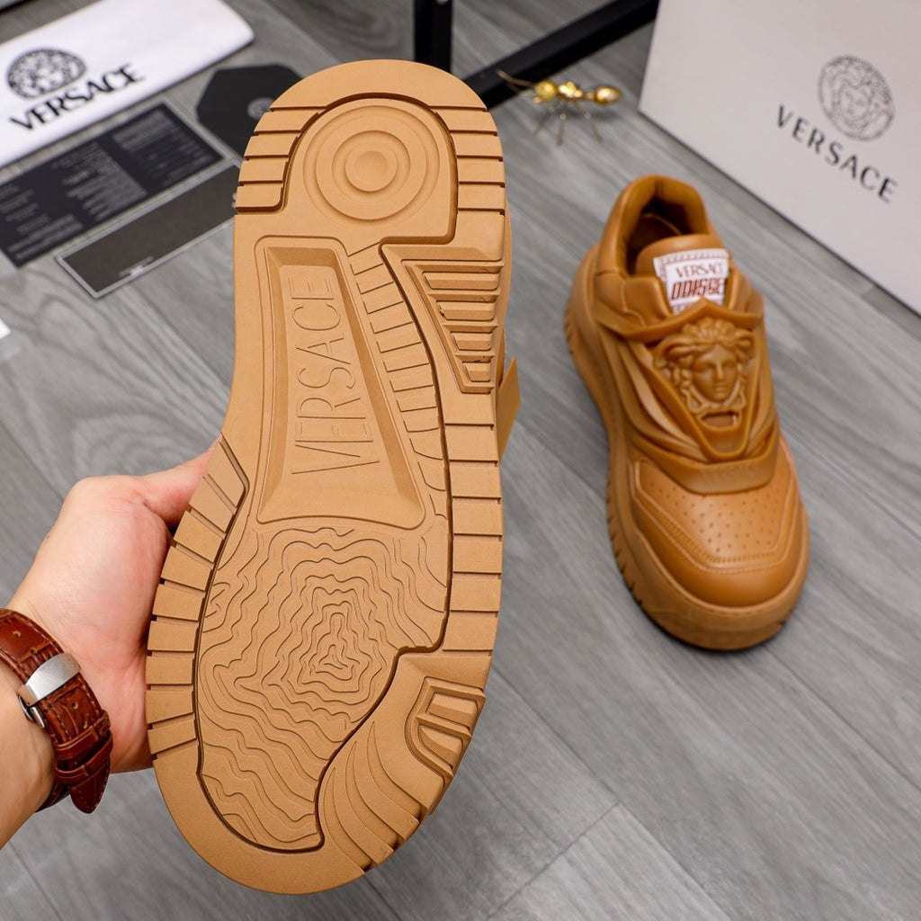 Luxury shoes: tan outsole with deep tread and hand-held shoe sole view