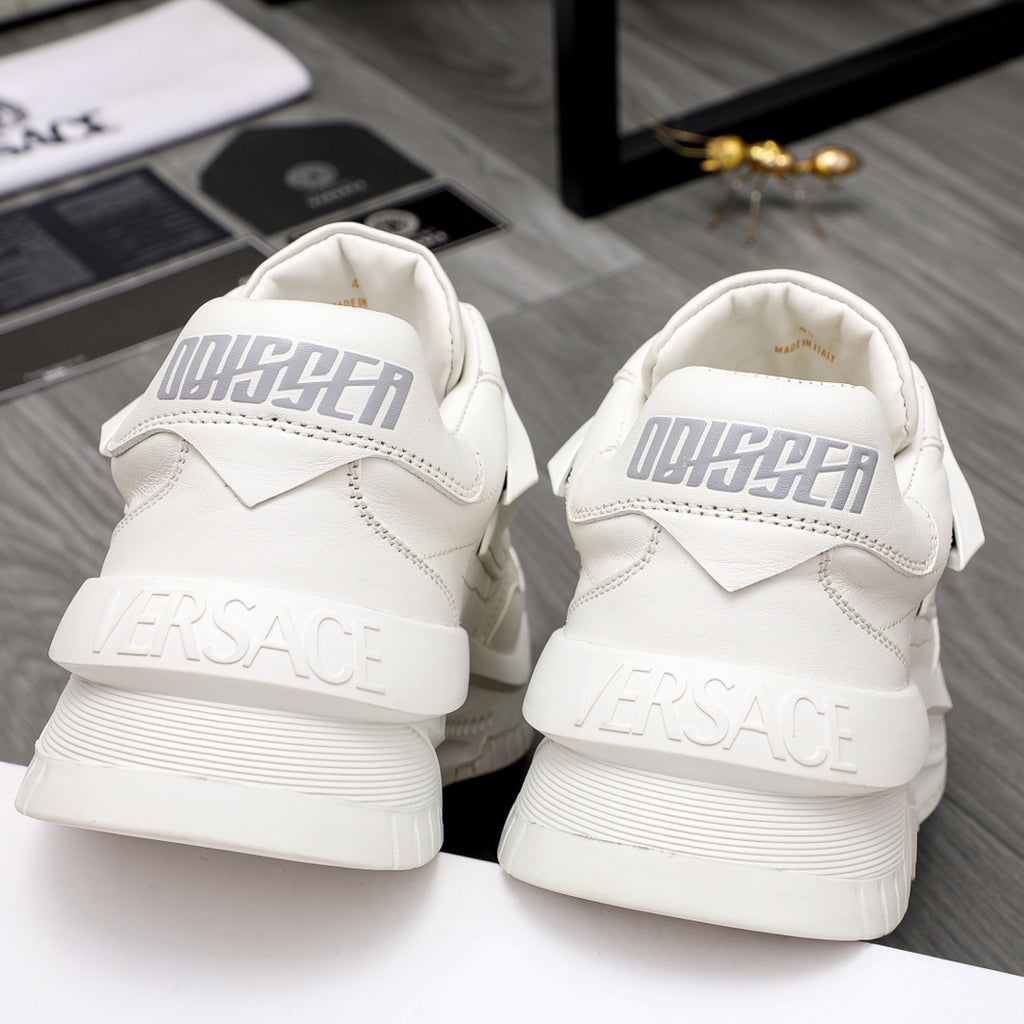 Back view of white Versace sneakers, large heel logo and chunky platform sole.