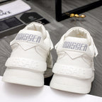 Back view of white Versace sneakers, large heel logo and chunky platform sole.