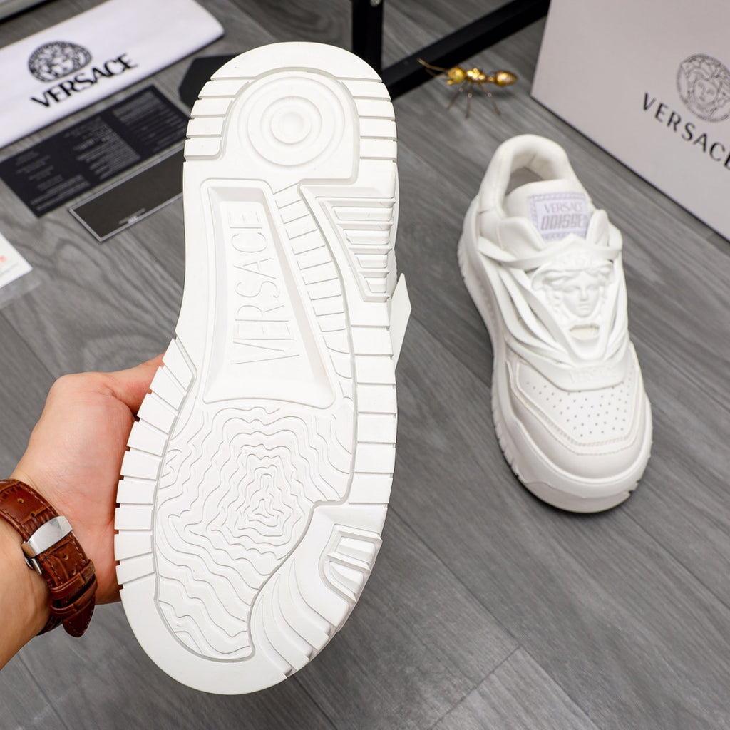 White Versace sneaker outsole tread shown, with matching shoe in the background.