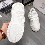 White Versace sneaker outsole tread shown, with matching shoe in the background.