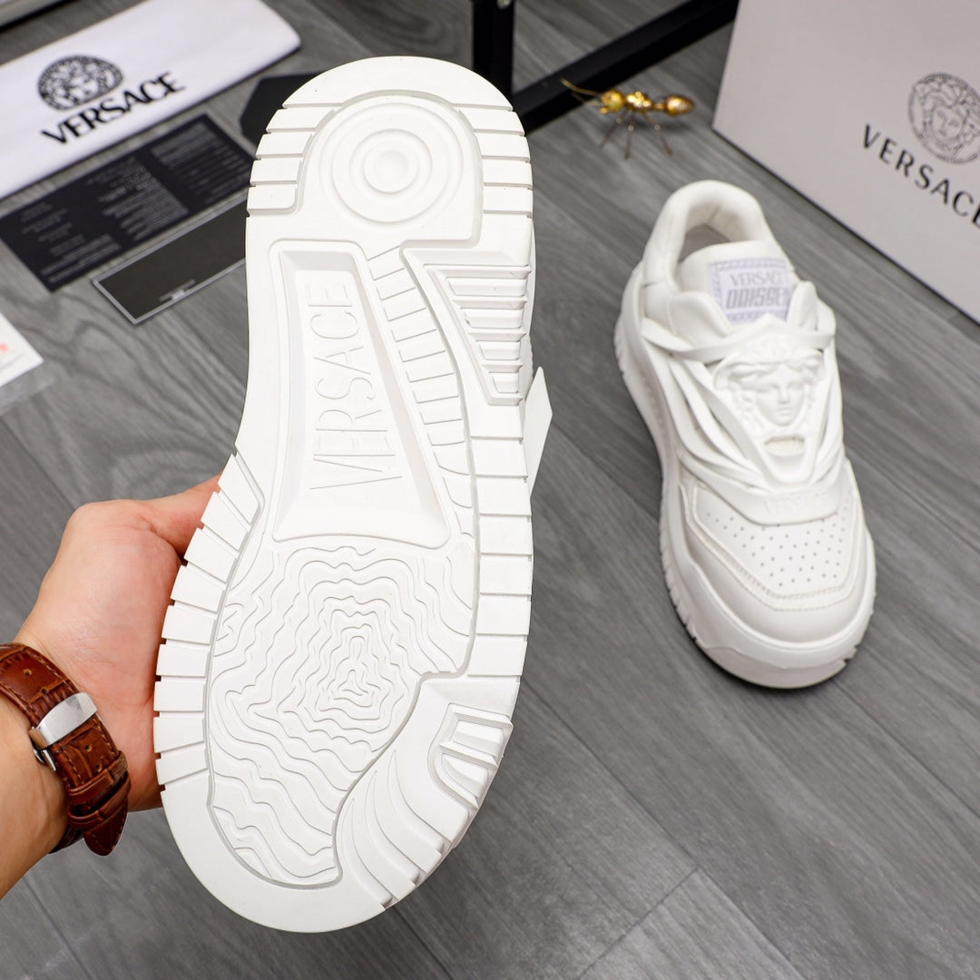 White Versace sneaker outsole tread shown, with matching shoe in the background.