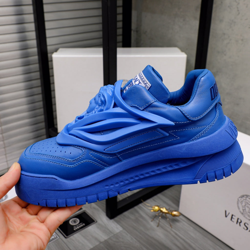 Blue Versace luxury sneakers, front view with ruffled side panel and thick sole