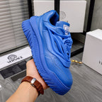 Blue Versace luxury sneakers with lion-head relief detail on the upper