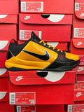 Yellow and black low-top basketball shoe with Nike swoosh on side