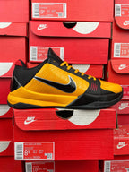 Yellow and black low-top basketball shoe with Nike swoosh on side