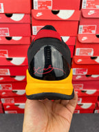 Yellow and black heel view of sneaker with black mesh upper and yellow midsole