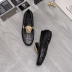 Versace black croc-texture loafers showing side profile and gold lion emblem