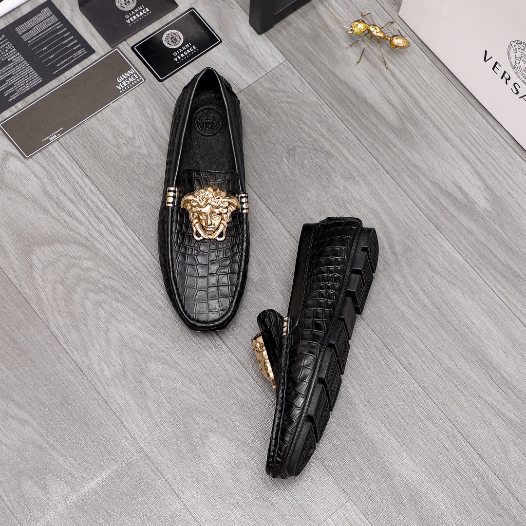Versace black croc-texture loafers showing side profile and gold lion emblem
