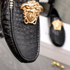 Versace black loafer upper close-up with gold lion head medallion and metal bars