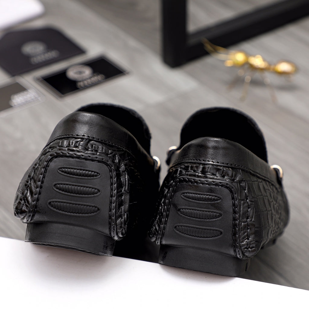 Versace black loafers viewed from heel with textured tread and side slit details