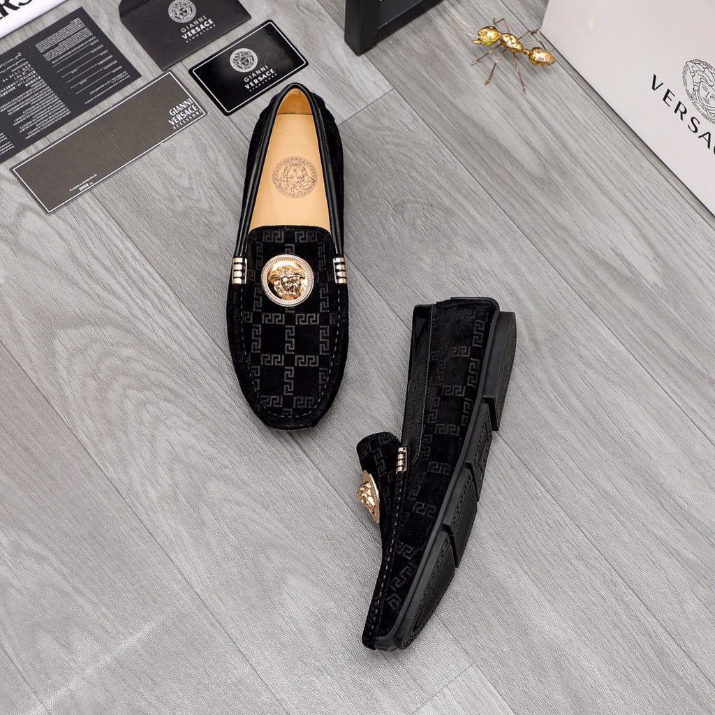 Versace black loafers set with Greca pattern uppers and gold medallion on top
