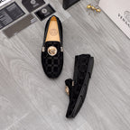 Versace black loafers set with Greca pattern uppers and gold medallion on top