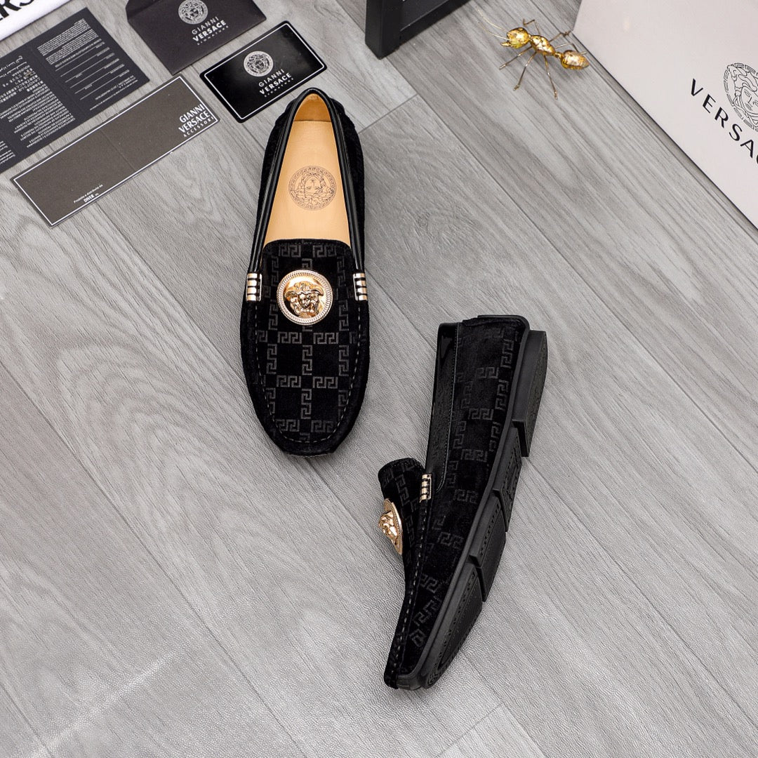 Versace black loafers set with Greca pattern uppers and gold medallion on top