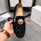 Versace black loafer with gold lion medallion at vamp and Greca logo side panel