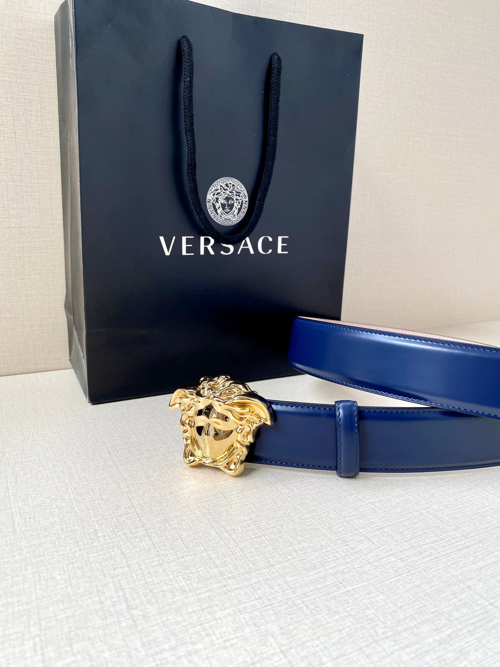 Blue leather belt with gold Medusa buckle and adjustable strap