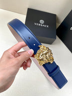 Blue leather belt with gold Medusa buckle detail and punched holes